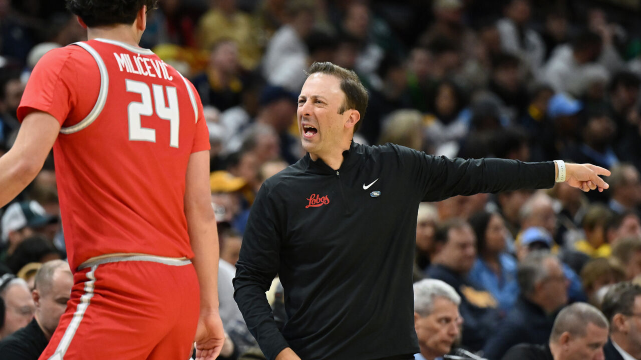 CLEVELAND, OHIO - MARCH 21: Head coach Richard Pitino of the New Mexico Lobos speaks to Jovan Milicevic #24 during the first half against the Marquette Golden Eagles in the first round of the NCAA Men's Basketball Tournament at Rocket Mortgage Fieldhouse on March 21, 2025 in Cleveland, Ohio.