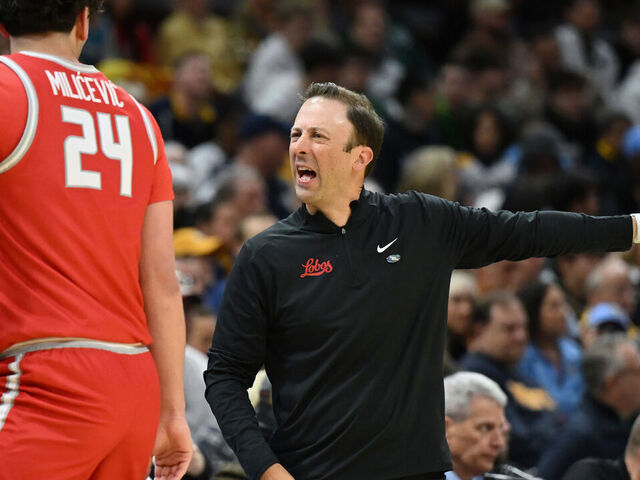 CLEVELAND, OHIO - MARCH 21: Head coach Richard Pitino of the New Mexico Lobos speaks to Jovan Milicevic #24 during the first half against the Marquette Golden Eagles in the first round of the NCAA Men's Basketball Tournament at Rocket Mortgage Fieldhouse on March 21, 2025 in Cleveland, Ohio.