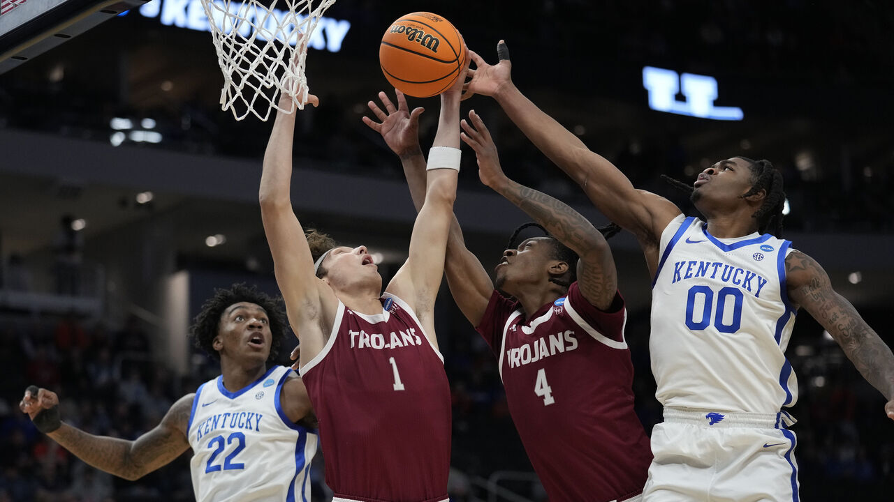 MILWAUKEE, WISCONSIN - MARCH 21: Thomas Dowd #1 of the Troy Trojans rebounds the ball against Otega Oweh #00 of the Kentucky Wildcats during the first half in the first round of the NCAA Men's Basketball Tournament at Fiserv Forum on March 21, 2025 in Milwaukee, Wisconsin.