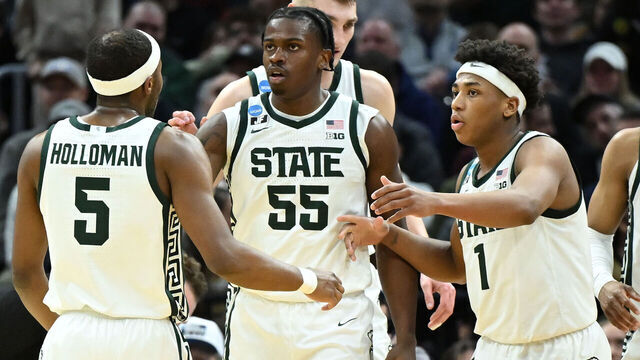 CLEVELAND, OHIO - MARCH 21: Coen Carr #55 of the Michigan State Spartans celebrates after his basket with Tre Holloman #5 and Jeremy Fears Jr. #1 during the first half against the Bryant University Bulldogs in the first round of the NCAA Men's Basketball Tournament at Rocket Mortgage Fieldhouse on March 21, 2025 in Cleveland, Ohio.