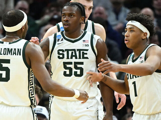 CLEVELAND, OHIO - MARCH 21: Coen Carr #55 of the Michigan State Spartans celebrates after his basket with Tre Holloman #5 and Jeremy Fears Jr. #1 during the first half against the Bryant University Bulldogs in the first round of the NCAA Men's Basketball Tournament at Rocket Mortgage Fieldhouse on March 21, 2025 in Cleveland, Ohio.
