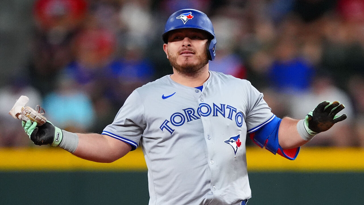 ARLINGTON, TEXAS - SEPTEMBER 17: Alejandro Kirk #30 of the Toronto Blue Jays gestures to his dugout from second base after hitting an RBI double during the first inning against the Texas Rangers at Globe Life Field on September 17, 2024 in Arlington, Texas.