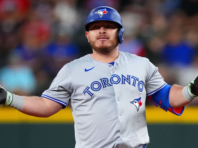 ARLINGTON, TEXAS - SEPTEMBER 17: Alejandro Kirk #30 of the Toronto Blue Jays gestures to his dugout from second base after hitting an RBI double during the first inning against the Texas Rangers at Globe Life Field on September 17, 2024 in Arlington, Texas.