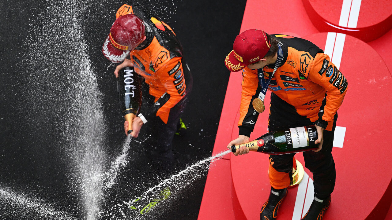 SHANGHAI, CHINA - MARCH 23: Second placed Lando Norris of Great Britain and McLaren and Race winner Oscar Piastri of Australia and McLaren celebrate on the podium with Champagne during the F1 Grand Prix of China at Shanghai International Circuit on March 23, 2025 in Shanghai, China.