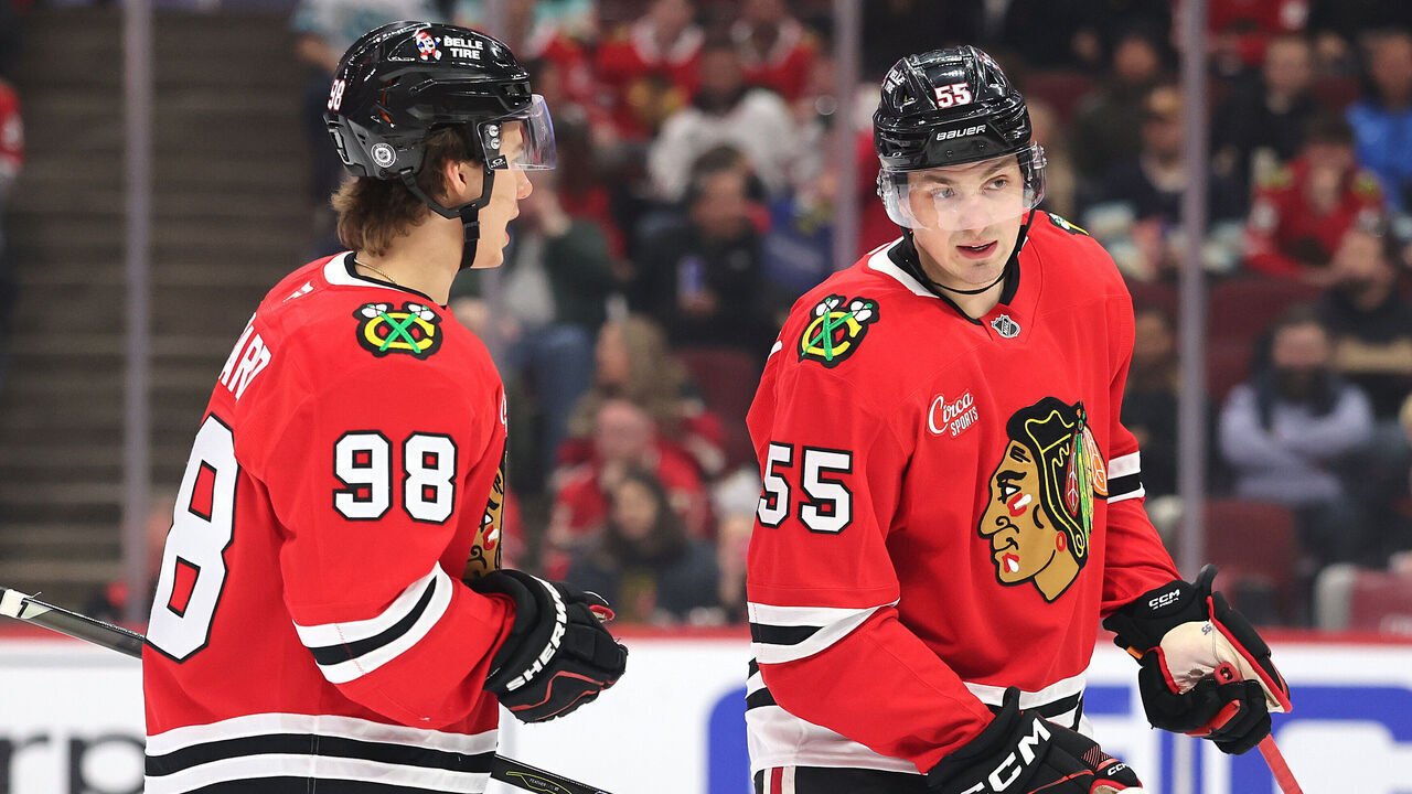 CHICAGO, ILLINOIS - MARCH 18: Connor Bedard #98 and Artyom Levshunov #55 of the Chicago Blackhawks confer against the Seattle Kraken during the first period at the United Center on March 18, 2025 in Chicago, Illinois.