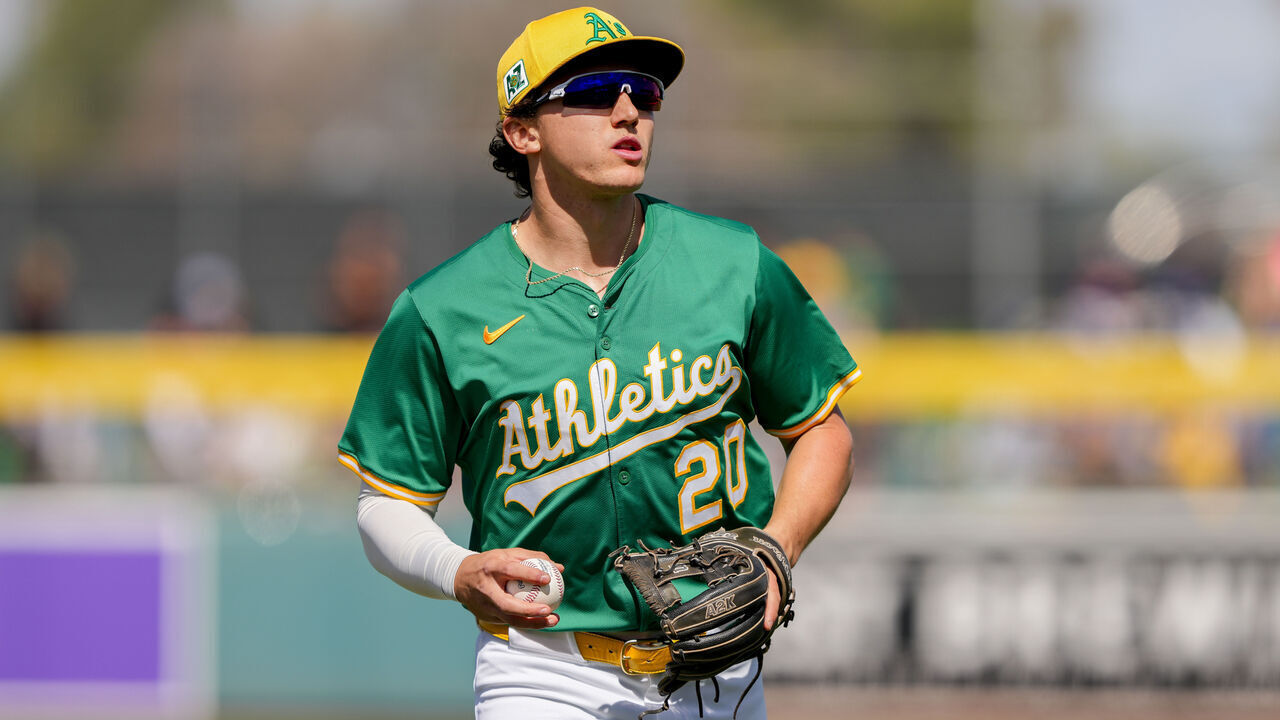 MESA, ARIZONA - MARCH 15: Zack Gelof #20 of the Athletics jogs across the field in the fourth inning against the Texas Rangers during a spring training game at HoHoKam Stadium on March 15, 2025 in Mesa, Arizona.