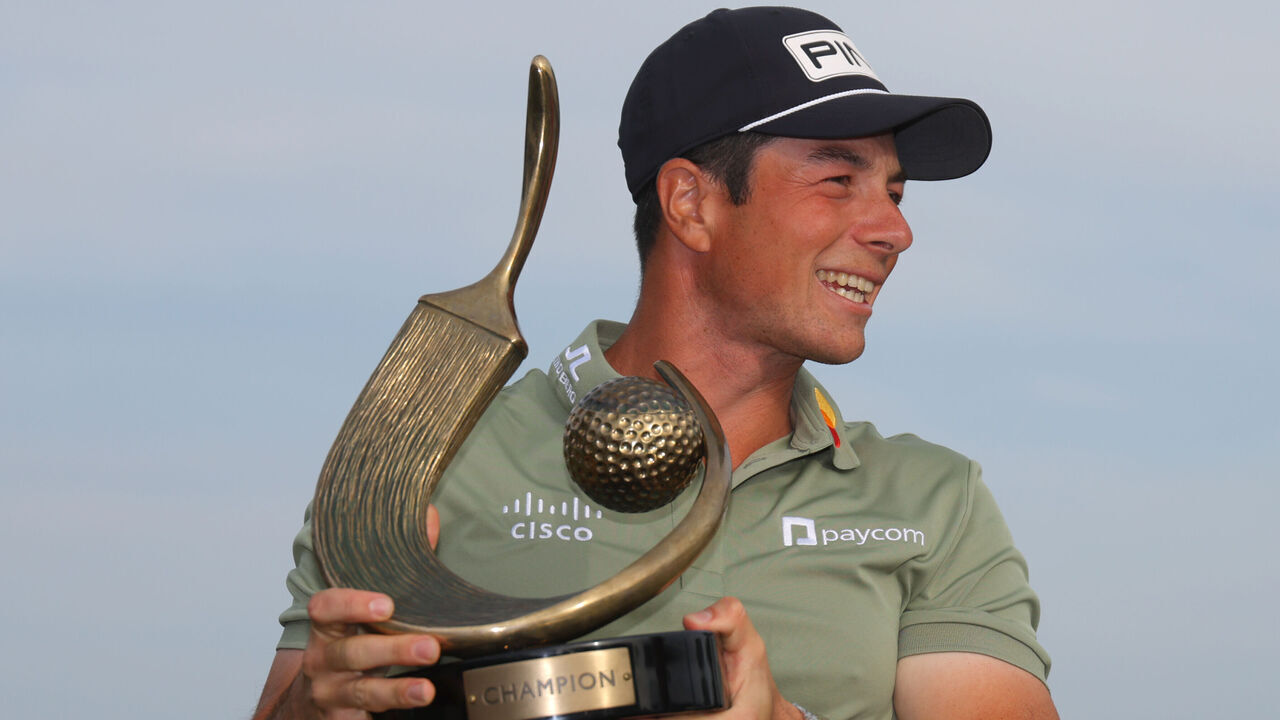 PALM HARBOR, FLORIDA - MARCH 23: Viktor Hovland of Norway poses with the trophy after putting in to win on the 18th green during the final round of the Valspar Championship 2025 at Innisbrook Resort and Golf Club on March 23, 2025 in Palm Harbor, Florida.