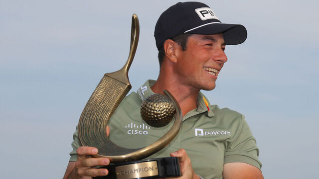 PALM HARBOR, FLORIDA - MARCH 23: Viktor Hovland of Norway poses with the trophy after putting in to win on the 18th green during the final round of the Valspar Championship 2025 at Innisbrook Resort and Golf Club on March 23, 2025 in Palm Harbor, Florida.