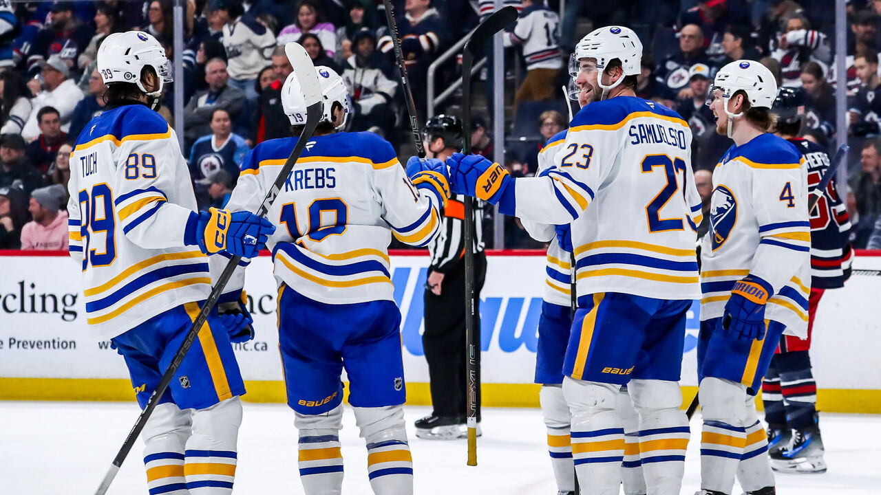 WINNIPEG, CANADA - MARCH 23: Alex Tuch #89, Peyton Krebs #19, Ryan McLeod #71, Mattias Samuelsson #23 and Bowen Byram #4 of the Buffalo Sabres celebrate a third period goal against the Winnipeg Jets at the Canada Life Centre on March 23, 2025 in Winnipeg, Manitoba, Canada.