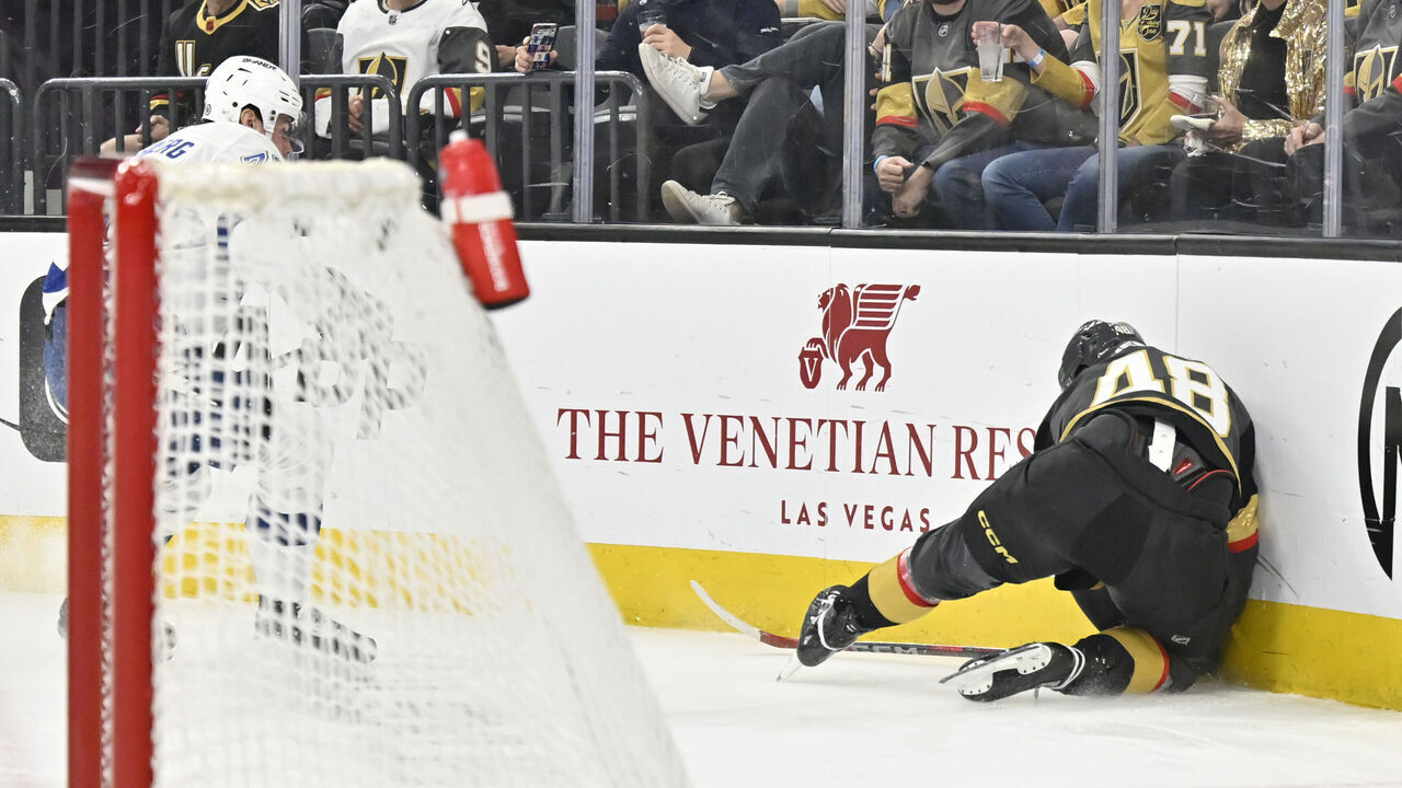 LAS VEGAS, NEVADA - MARCH 23: Tomas Hertl #48 of the Vegas Golden Knights crashes into the boards after a shove from Emil Lilleberg #78 of the Tampa Bay Lightning \d3p at T-Mobile Arena on March 23, 2025 in Las Vegas, Nevada.