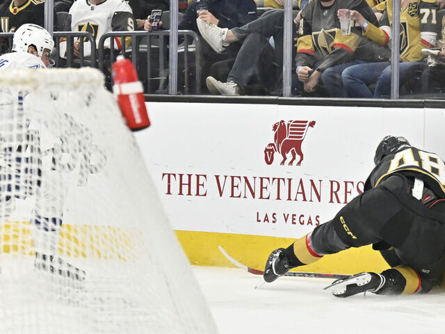 LAS VEGAS, NEVADA - MARCH 23: Tomas Hertl #48 of the Vegas Golden Knights crashes into the boards after a shove from Emil Lilleberg #78 of the Tampa Bay Lightning \d3p at T-Mobile Arena on March 23, 2025 in Las Vegas, Nevada.