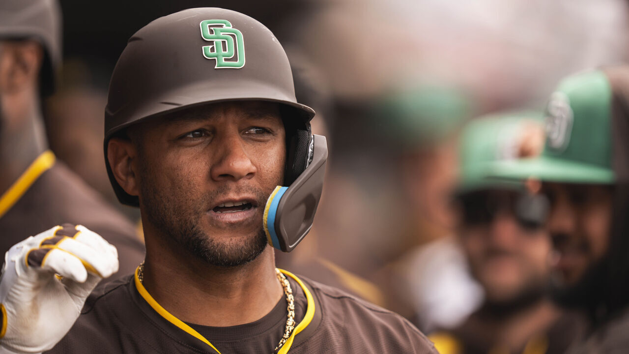 PEORIA, ARIZONA - MARCH 17: Yuli Gurriel #10 of the San Diego Padres celebrates in the dugout after hitting a home run during a spring training game against the Milwaukee Brewers at Peoria Stadium on March 17, 2025 in Peoria, Arizona. Players wore green hats to celebrate St. Patrick's Day.