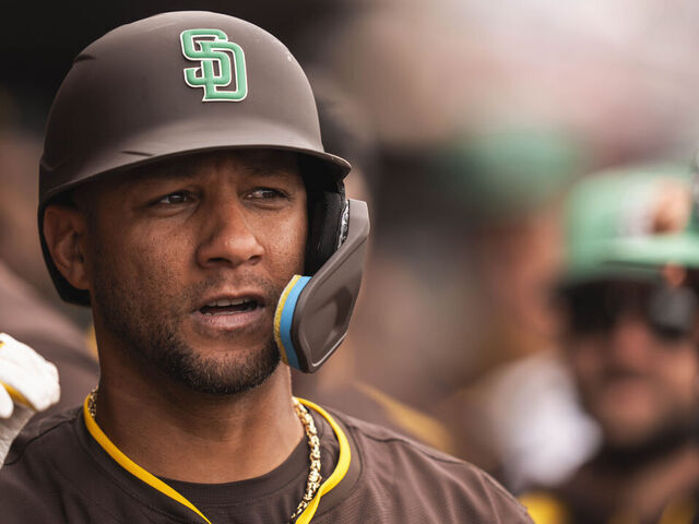 PEORIA, ARIZONA - MARCH 17: Yuli Gurriel #10 of the San Diego Padres celebrates in the dugout after hitting a home run during a spring training game against the Milwaukee Brewers at Peoria Stadium on March 17, 2025 in Peoria, Arizona. Players wore green hats to celebrate St. Patrick's Day.