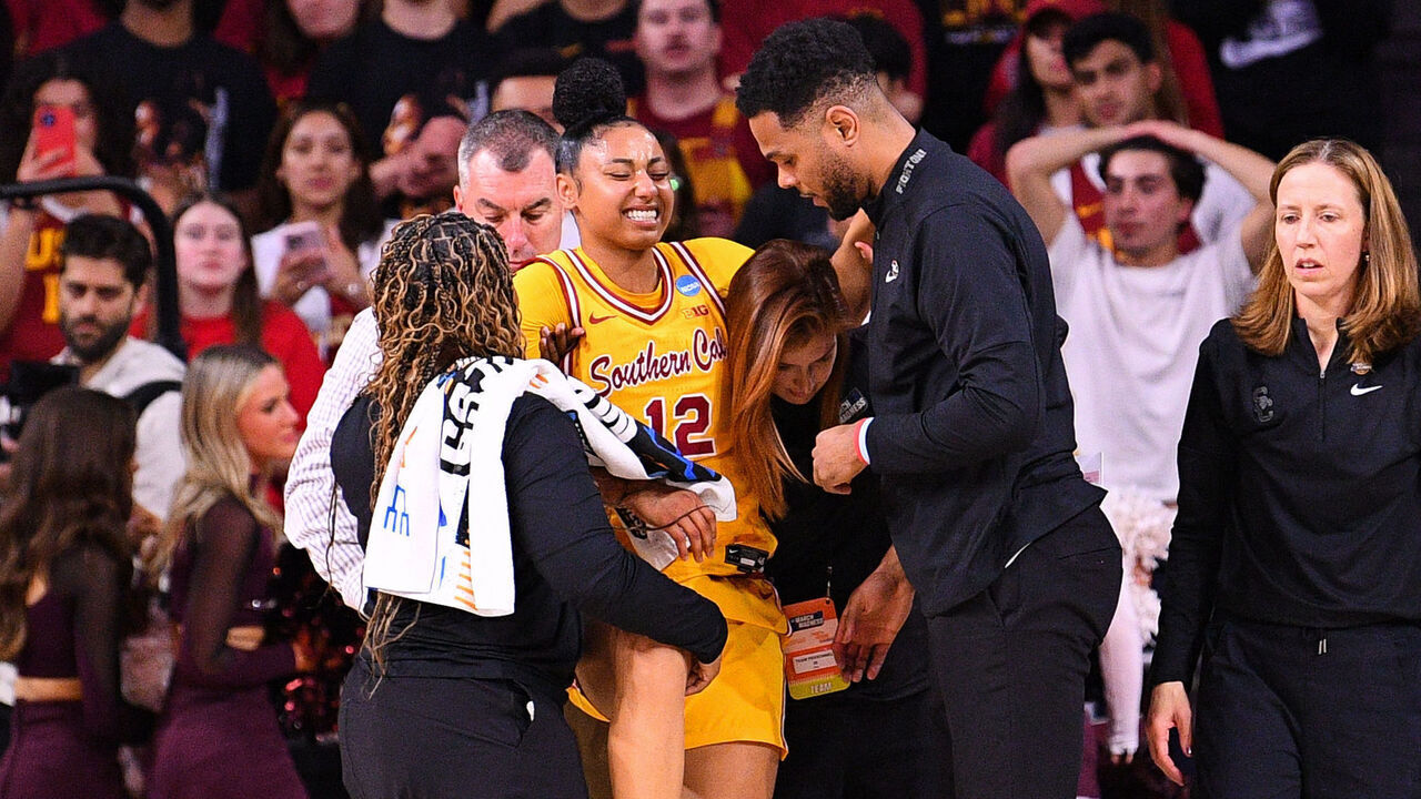 LOS ANGELES, CA - MARCH 24: USC Trojans guard JuJu Watkins (12) is helped off the court after being injured as USC Trojans head coach Lindsay Gottlieb looks on during the Mississippi State Bulldogs game versus the USC Trojans in the second round of the NCAA Division I Women's Championship on March 24, 2025, at the Galen Center in Los Angeles, CA.
