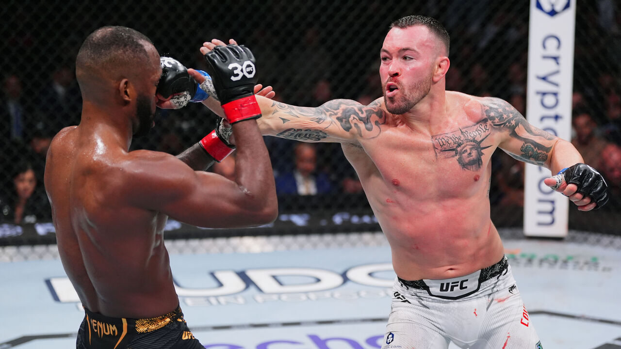 LAS VEGAS, NEVADA - DECEMBER 16: (R-L) Colby Covington punches Leon Edwards of Jamaica in the UFC welterweight championship fight during the UFC 296 event at T-Mobile Arena on December 16, 2023 in Las Vegas, Nevada.