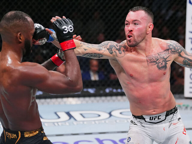 LAS VEGAS, NEVADA - DECEMBER 16: (R-L) Colby Covington punches Leon Edwards of Jamaica in the UFC welterweight championship fight during the UFC 296 event at T-Mobile Arena on December 16, 2023 in Las Vegas, Nevada.