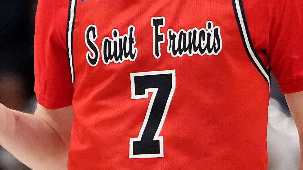 DAYTON, OHIO - MARCH 18: Jeremy Clayville #7 of the St. Francis (Pa) Red Flash celebrates a three point basket during the second half against the Alabama State Hornets in the First Four game of the NCAA Men's Basketball Tournament at University of Dayton Arena on March 18, 2025 in Dayton, Ohio.