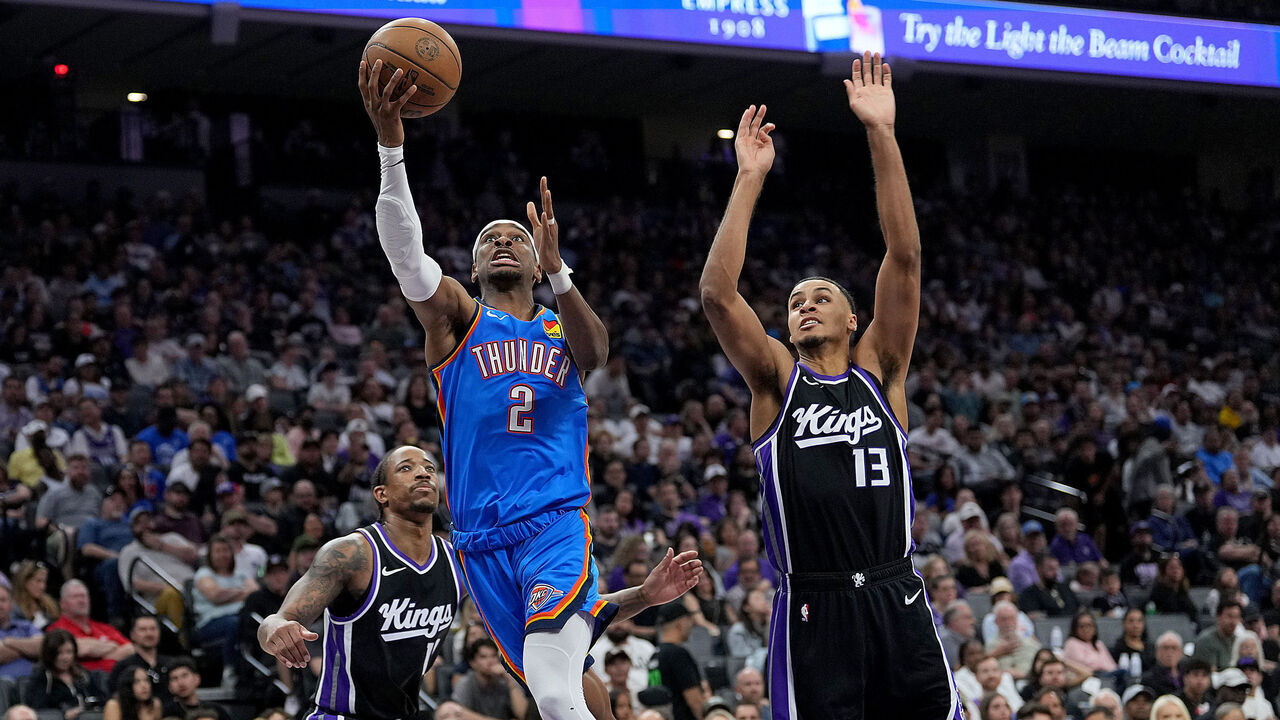SACRAMENTO, CALIFORNIA - MARCH 25: Shai Gilgeous-Alexander #2 of the Oklahoma City Thunder shoots a layup against Keegan Murray #13 of the Sacramento Kings during the first half at Golden 1 Center on March 25, 2025 in Sacramento, California.