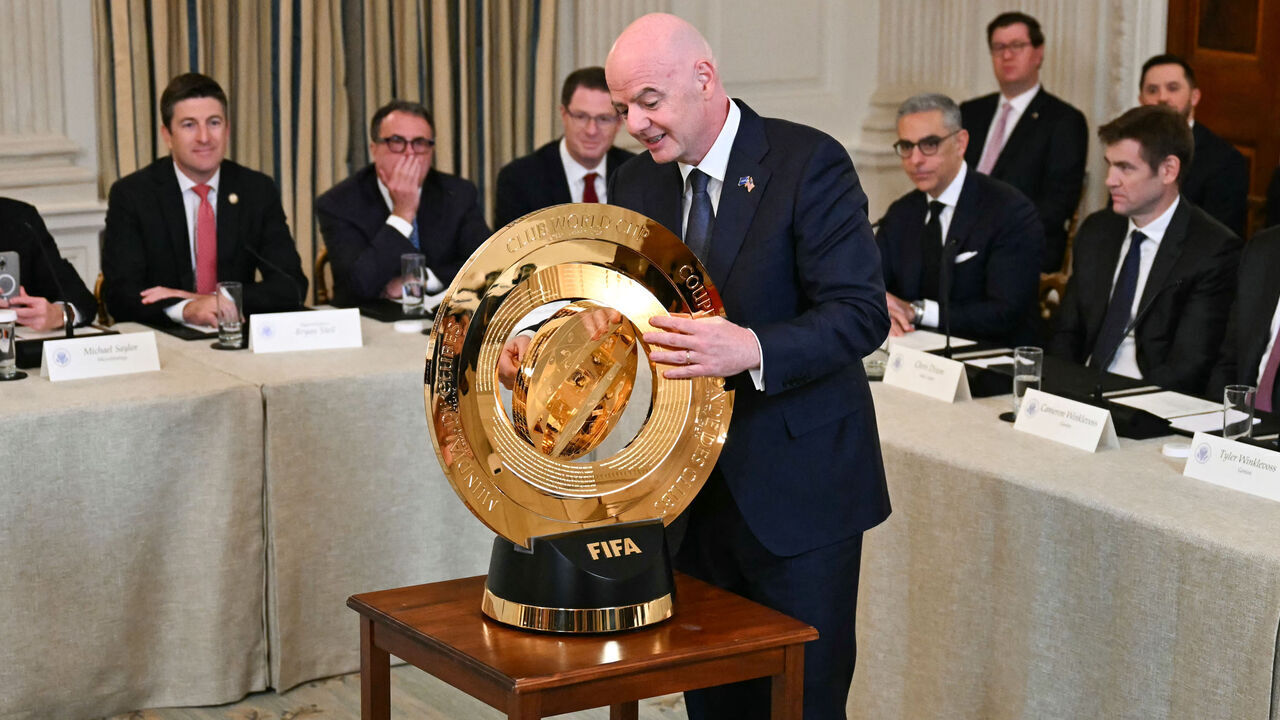 FIFA president (Fédération Internationale de Football Association) Gianni Infantino unlocks the new FIFA Club World Cup trophy during the White House Crypto Summit in Washington, DC, March 7, 2025.