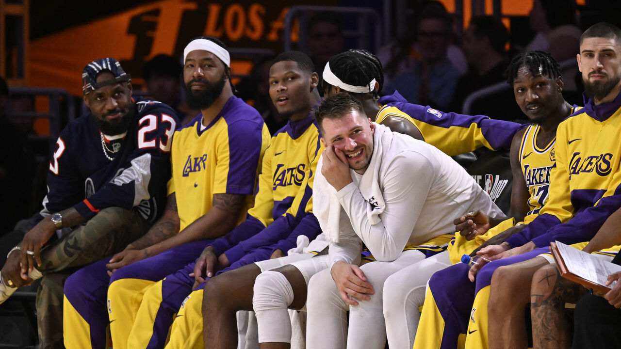 Los Angeles, CA - March 19: LeBron James, left, reacts on the bench along teammates including Luka Doncic, center, of the Los Angeles Lakers in the second half of a NBA basketball game against the Denver Nuggets at Crypto.com Arena in Los Angeles on Wednesday, March 19, 2025.