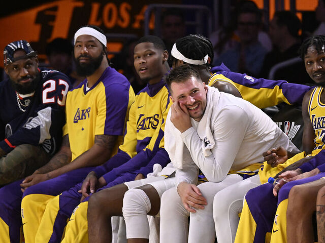 Los Angeles, CA - March 19: LeBron James, left, reacts on the bench along teammates including Luka Doncic, center, of the Los Angeles Lakers in the second half of a NBA basketball game against the Denver Nuggets at Crypto.com Arena in Los Angeles on Wednesday, March 19, 2025.