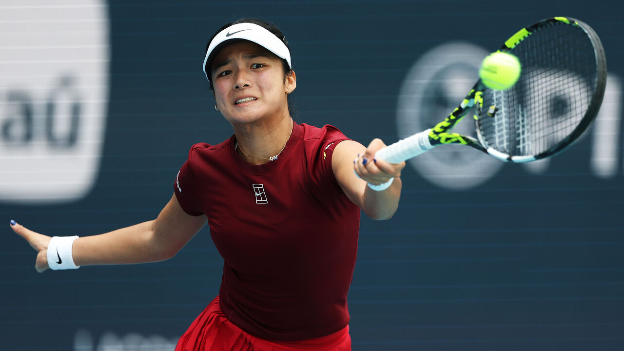 MIAMI GARDENS, FLORIDA - MARCH 26: Alexandra Eala of the Philippines returns a shot against Iga Swiatek of Poland during their matchon Day 9 of the Miami Open at Hard Rock Stadium on March 26, 2025 in Miami Gardens, Florida.