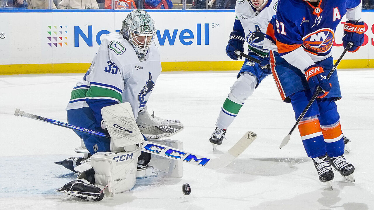 ELMONT, NEW YORK - MARCH 26: Thatcher Demko #35 of the Vancouver Canucks makes a save against Kyle Palmieri #21 of the New York Islanders during the third period at UBS Arena on March 26, 2025 in Elmont, New York.