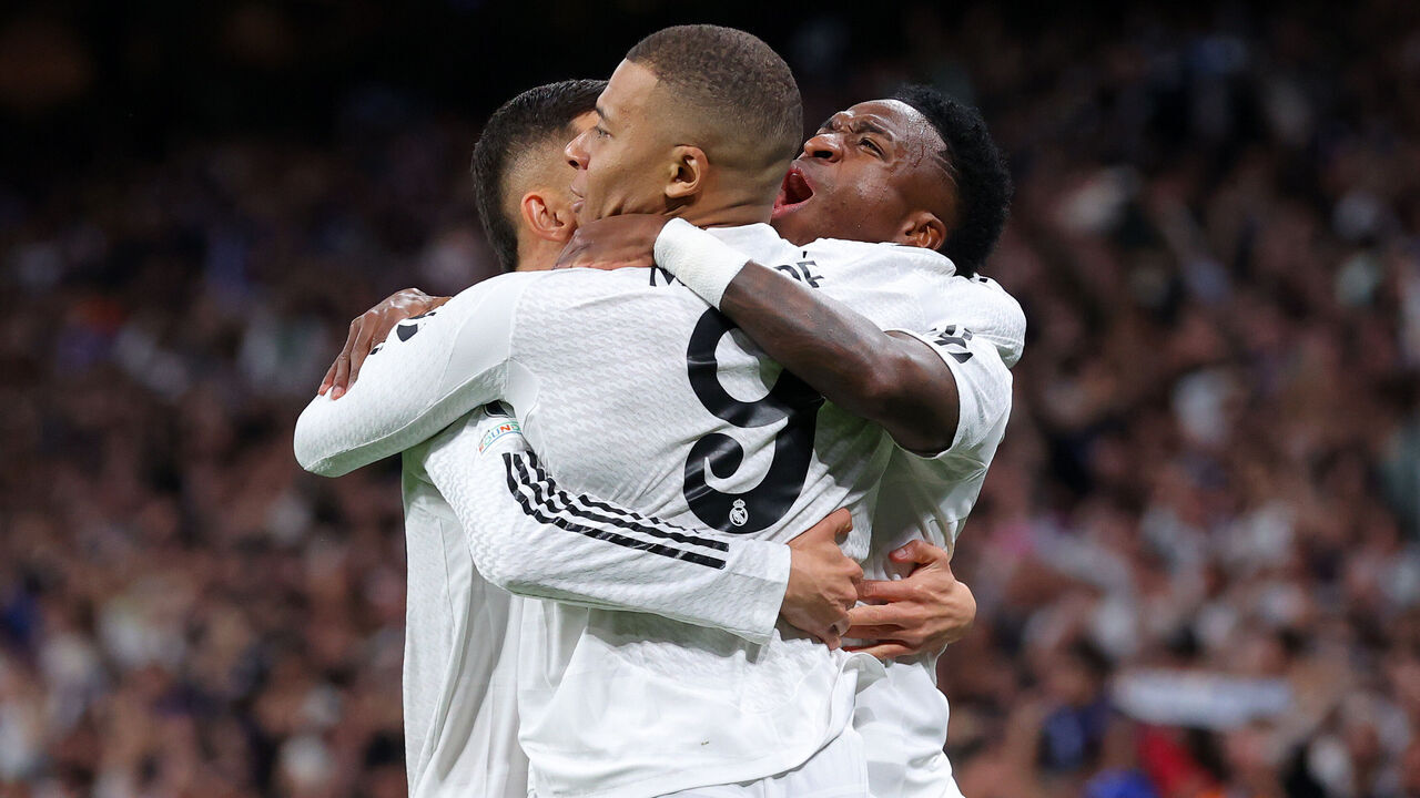 MADRID, SPAIN - FEBRUARY 19: Kylian Mbappe of Real Madrid celebrates with Vinicius Junior after scoring their second goal during the UEFA Champions League 2024/25 League Knockout Play-off second leg match between Real Madrid C.F. and Manchester City at Santiago Bernabeu Stadium on February 19, 2025 in Madrid, Spain.