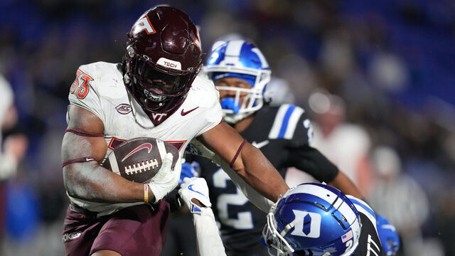 DURHAM, NORTH CAROLINA - NOVEMBER 23: Bhayshul Tuten #33 of the Virginia Tech Hokies stiff-arms Joshua Pickett #26 of the Duke Blue Devils during the second half of the game at Wallace Wade Stadium on November 23, 2024 in Durham, North Carolina. The Blue Devils won 31-28.