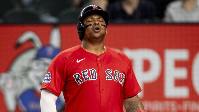 ARLINGTON, TEXAS - MARCH 28: Rafael Devers #11 of the Boston Red Sox reacts as he bats during the third inning of a game against the Texas Rangers on March 28, 2025 at Globe Life Field in Arlington, Texas.