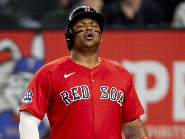 ARLINGTON, TEXAS - MARCH 28: Rafael Devers #11 of the Boston Red Sox reacts as he bats during the third inning of a game against the Texas Rangers on March 28, 2025 at Globe Life Field in Arlington, Texas.