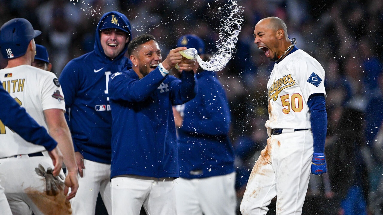 Los Angeles, CA - March 28:Dodgers Mookie Betts, #50, is showered by teammates after hitting a walk-off home run to defeat the Tigers 8-5 in the bottom of the 10th inning at Dodger Stadium on Friday, March 28, 2025. g