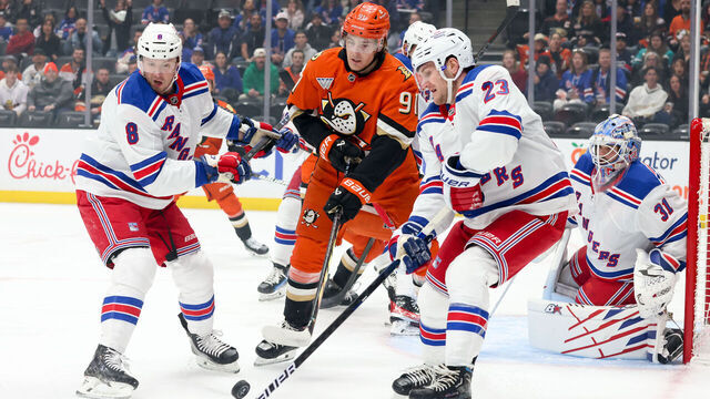 ANAHEIM, CA - MARCH 28: J.T. Miller #8 of the New York Rangers, Leo Carlsson #91 of the Anaheim Ducks and Adam Fox #23 of the New York Rangers battle for the puck during the first period at Honda Center on March 28, 2025 in Anaheim, California.