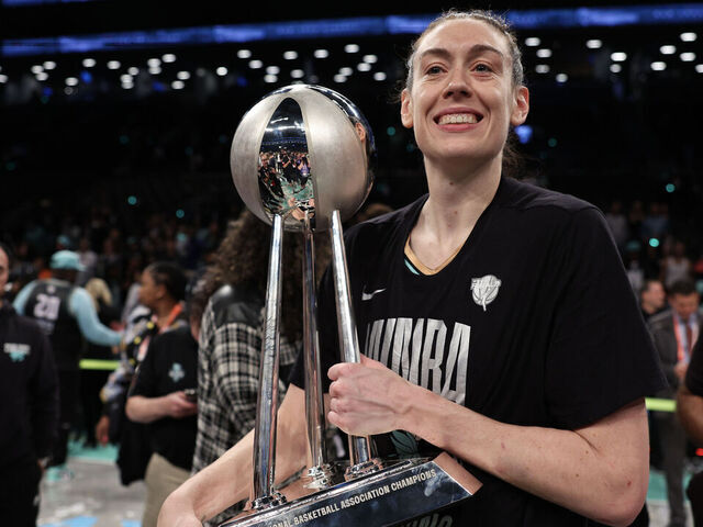 NEW YORK, NEW YORK - OCTOBER 20: Breanna Stewart #30 of the New York Liberty celebrates with the WNBA Championship Trophy after winning Game Five of the WNBA Finals at Barclays Center on October 20, 2024 in New York City.