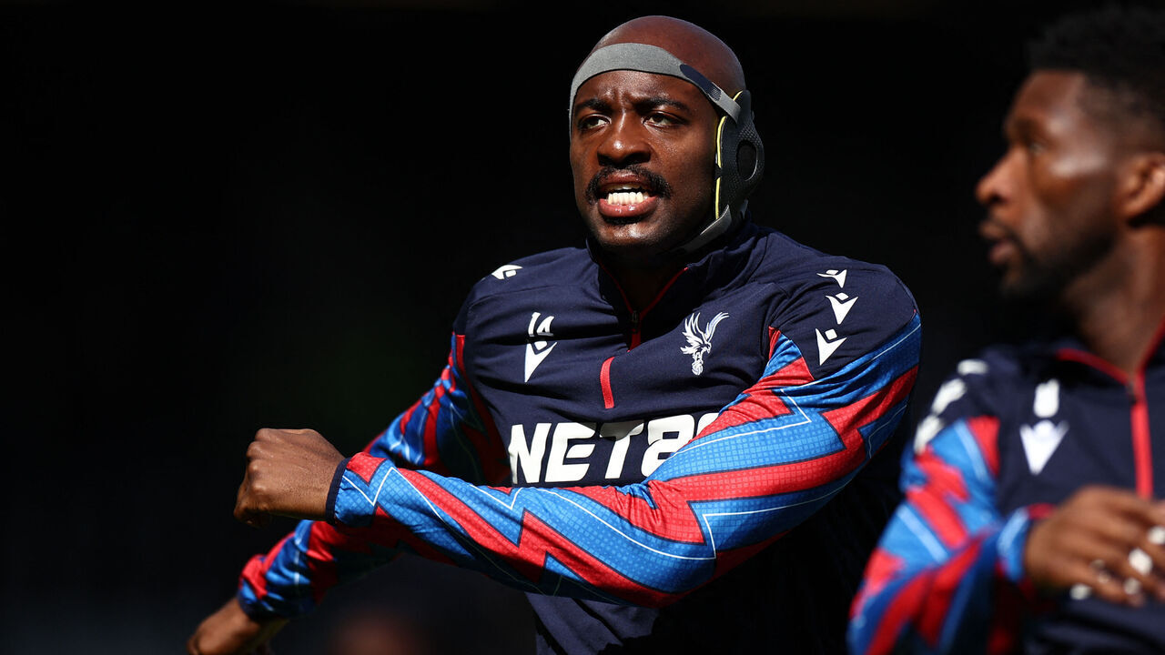 Crystal Palace's French striker #14 Jean-Philippe Mateta warms up wearing a protective headguard ahead of the English FA Cup quarter-final football match between Fulham and Crystal Palace at Craven Cottage in Fulham, west London on March 29, 2025.