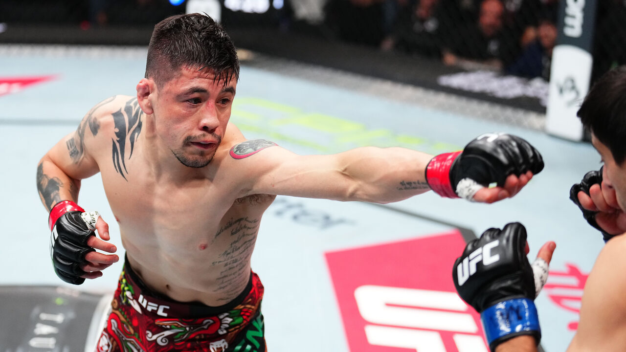 MEXICO CITY, MEXICO - MARCH 29: (L-R) Brandon Moreno of Mexico punches Steve Erceg of Australia in a flyweight fight during the UFC Fight Night event at CDMX Arena on March 29, 2025 in Mexico City, Mexico.
