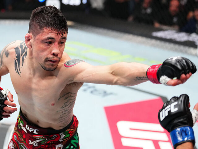 MEXICO CITY, MEXICO - MARCH 29: (L-R) Brandon Moreno of Mexico punches Steve Erceg of Australia in a flyweight fight during the UFC Fight Night event at CDMX Arena on March 29, 2025 in Mexico City, Mexico.