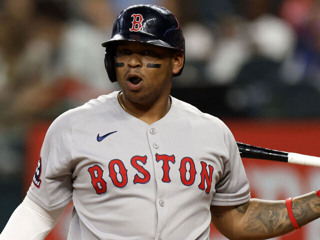 ARLINGTON, TX - MARCH 29: Rafael Devers #11 of the Boston Red Sox reacts during an at bat against the Texas Rangers during the second inning at Globe Life Field on March 29, 2025 in Arlington, Texas.