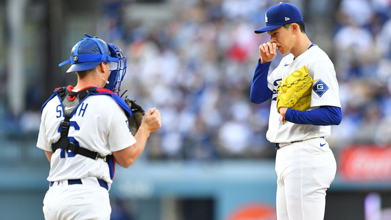 LOS ANGELES, CA - MARCH 29: Los Angeles Dodgers catcher Will Smith (16) goes out to talk to Los Angeles Dodgers pitcher Roki Sasaki (11) during the MLB game between the Detroit Tigers and the Los Angeles Dodgers on March 29, 2025 at Dodger Stadium in Los Angeles, CA.