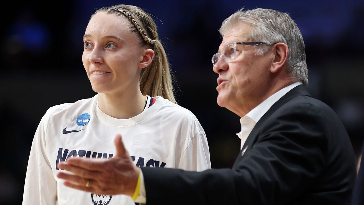 SPOKANE, WASHINGTON - MARCH 29: Paige Bueckers #5 of the Connecticut Huskies meets with head coach Geno Auriemma at halftime against the Oklahoma Sooners in the Sweet Sixteen round of the NCAA Women's Basketball Tournament at Spokane Arena on March 29, 2025 in Spokane, Washington.