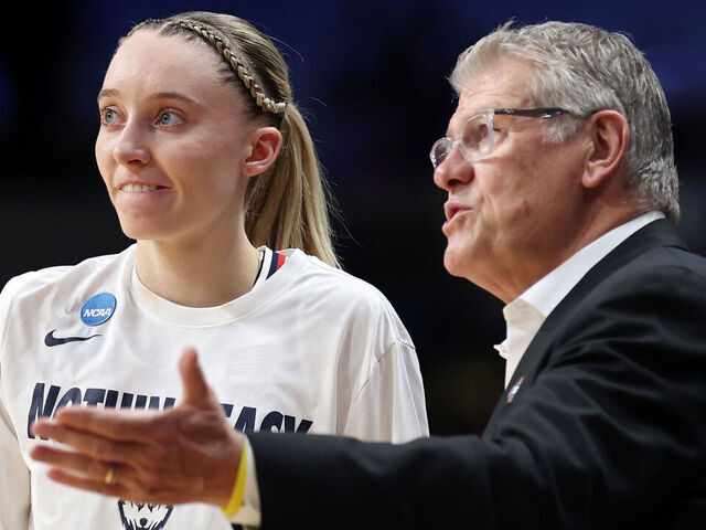 SPOKANE, WASHINGTON - MARCH 29: Paige Bueckers #5 of the Connecticut Huskies meets with head coach Geno Auriemma at halftime against the Oklahoma Sooners in the Sweet Sixteen round of the NCAA Women's Basketball Tournament at Spokane Arena on March 29, 2025 in Spokane, Washington.