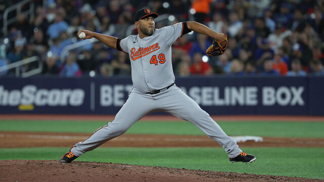 TORONTO, CANADA - MARCH 28: Albert Suárez #49 of the Baltimore Orioles pitches during the fifth inning in the game against the Toronto Blue Jays at Rogers Centre on March 28, 2025 in Toronto, Canada.