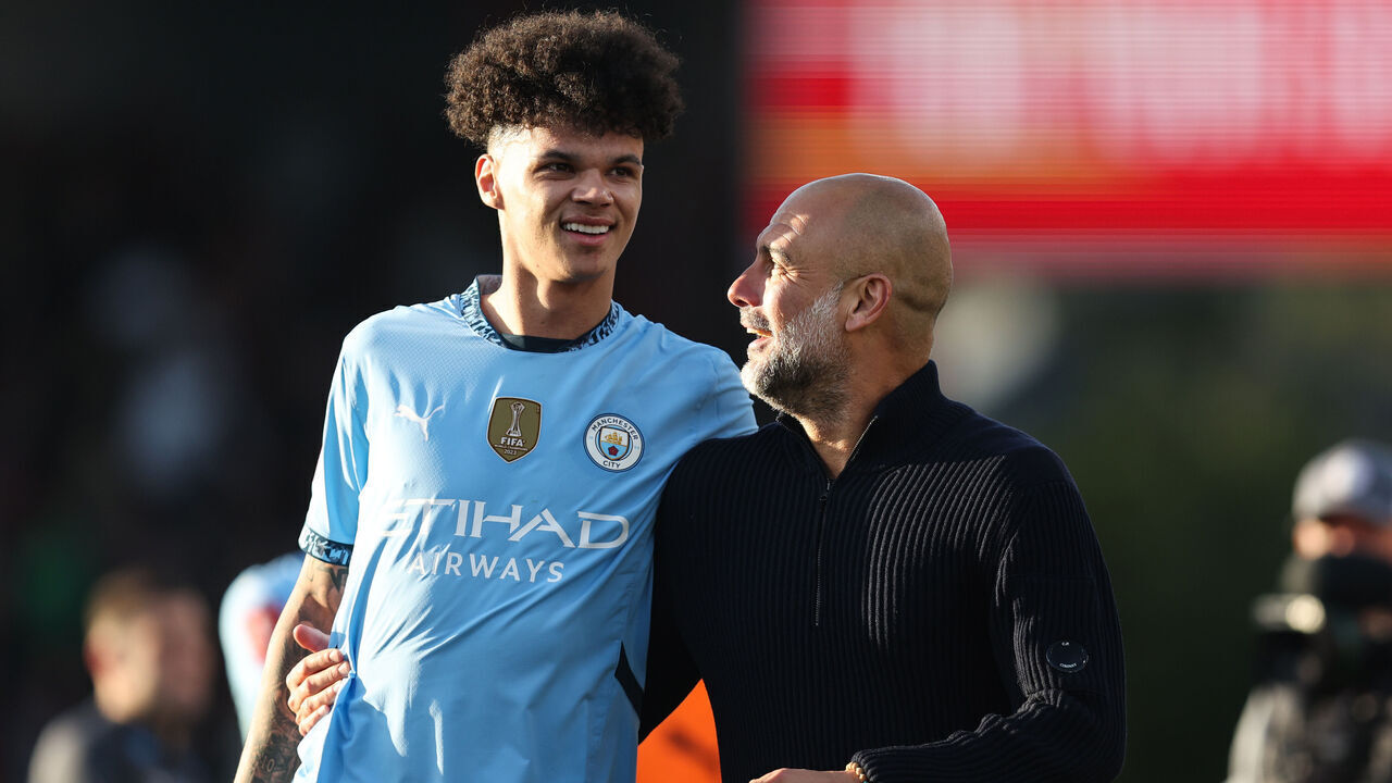 BOURNEMOUTH, ENGLAND - MARCH 30: Manchester City manager Pep Guardiola looks up to Nico O'Reilly of Manchester City during the Emirates FA Cup Quarter Final match between AFC Bournemouth and Manchester City at Vitality Stadium on March 30, 2025 in Bournemouth, England.