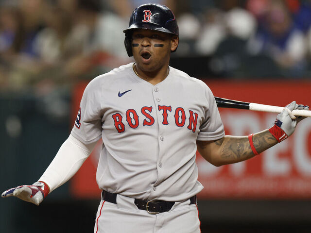 ARLINGTON, TX - MARCH 29: Rafael Devers #11 of the Boston Red Sox reacts during an at bat against the Texas Rangers during the second inning at Globe Life Field on March 29, 2025 in Arlington, Texas.
