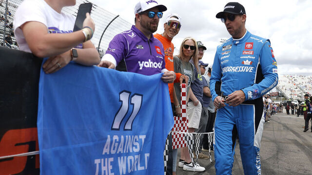MARTINSVILLE, VA - MARCH 30: Denny Hamlin (#11 Joe Gibbs Racing Progressive Toyota) poses with fans on pit road prior to the running of the NASCAR Cup Series Cook Out 400 on march 30, 2025 at Martinsville Speedway in Martinsville, VA.