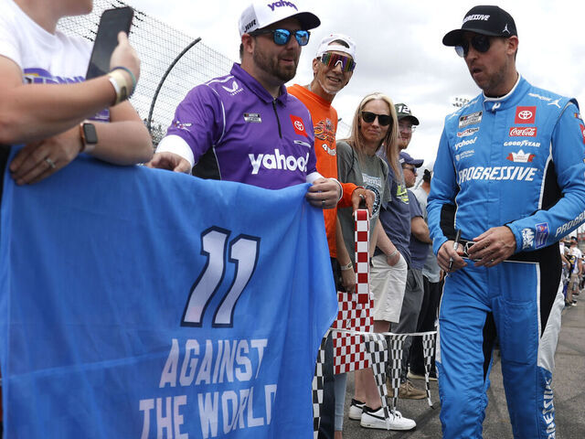 MARTINSVILLE, VA - MARCH 30: Denny Hamlin (#11 Joe Gibbs Racing Progressive Toyota) poses with fans on pit road prior to the running of the NASCAR Cup Series Cook Out 400 on march 30, 2025 at Martinsville Speedway in Martinsville, VA.