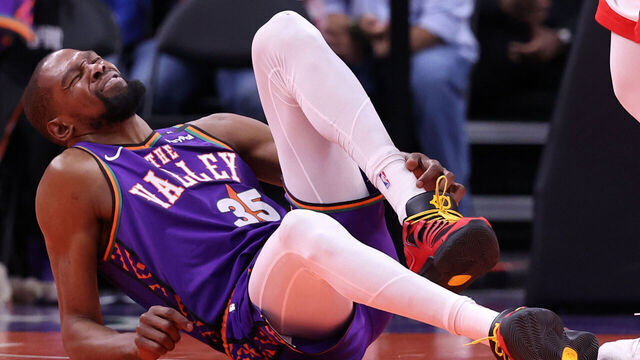 PHOENIX, ARIZONA - MARCH 30: Kevin Durant #35 of the Phoenix Suns reacts after an apparent injury during the second half against the Houston Rockets at PHX Arena on March 30, 2025 in Phoenix, Arizona.