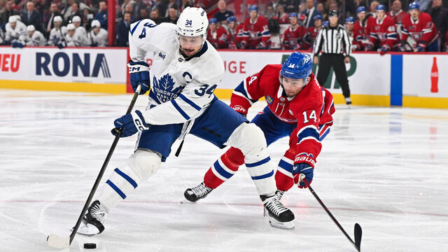 MONTREAL, CANADA - OCTOBER 09: Auston Matthews #34 of the Toronto Maple Leafs skates the puck against Nick Suzuki #14 of the Montreal Canadiens during the third period in the home opener at the Bell Centre on October 9, 2024 in Montreal, Quebec, Canada. The Montreal Canadiens defeated the Toronto Maple Leafs 1-0.
