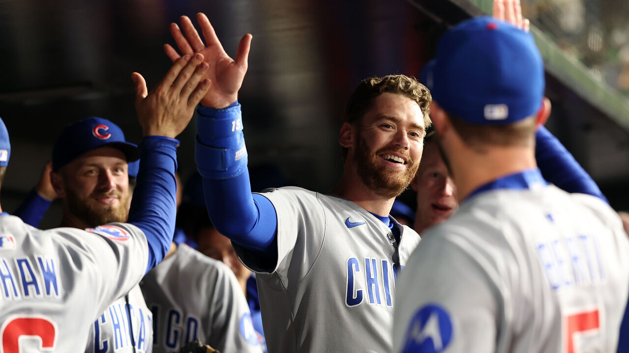 SACRAMENTO, CALIFORNIA - MARCH 31: Carson Kelly #15 of the Chicago Cubs is congratulated by teammates after the eighth inning, in which he hit a triple to complete hitting for the cycle, at Sutter Health Park on March 31, 2025 in Sacramento, California.