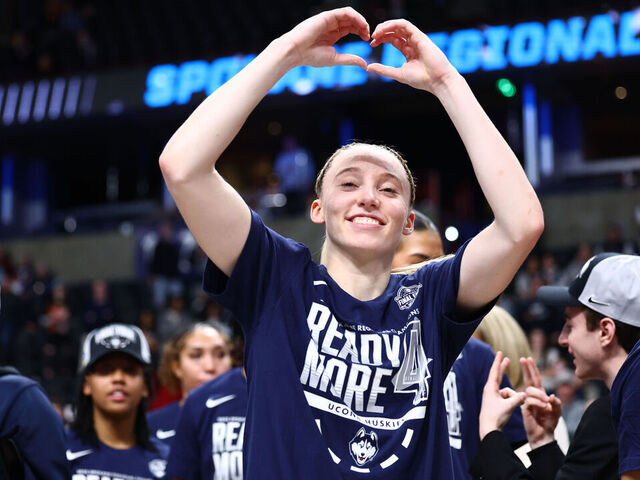SPOKANE, WASHINGTON - MARCH 31: Paige Bueckers #5 of the UConn Huskies celebrates on the court with her teammates after beating the USC Trojans 78-64 to advance to the Final Four during the Elite Eight round of the 2025 NCAA Women's Basketball Tournament held at Spokane Arena on March 31, 2025 in Spokane, Washington.
